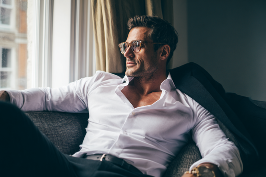 A modern man in a clean and refined lifestyle setting expressing vitality, confidence, and awareness of long-term wellness management