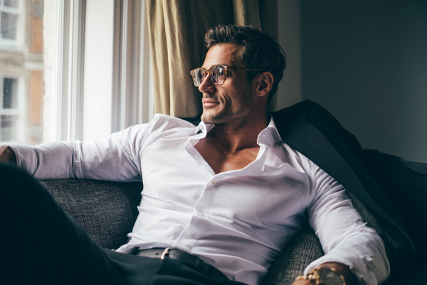 A modern man in a clean and refined lifestyle setting expressing vitality, confidence, and awareness of long-term wellness management