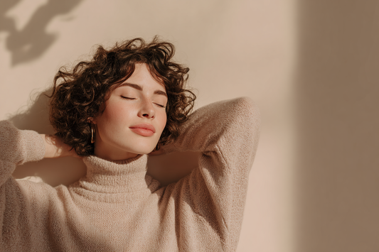 A calm modern woman in a refined self-care setting representing consistency, daily feminine wellness, and sustainable routine support