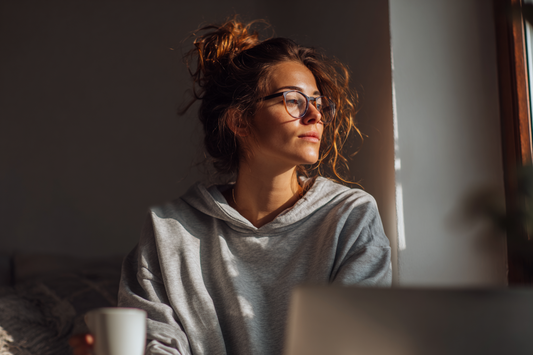 A modern woman in a calm but busy lifestyle setting representing feminine comfort, routine disruption awareness, and practical self-care support