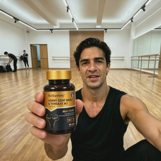 A man in a dance studio holding a BioHarmony Horny Goat Weed & Tongkat Ali bottle toward the camera. (影片 / video)