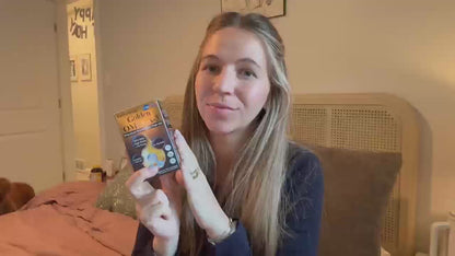 Customer review video thumbnail of a woman holding BioHarmony Golden Omega-3 fish oil box in a bedroom (影片 / video)